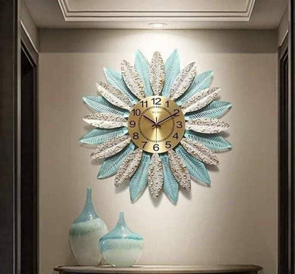 Metallic feather leaf wall clock by The Gharnish, 30-inch round clock with a decorative feather and leaf design.