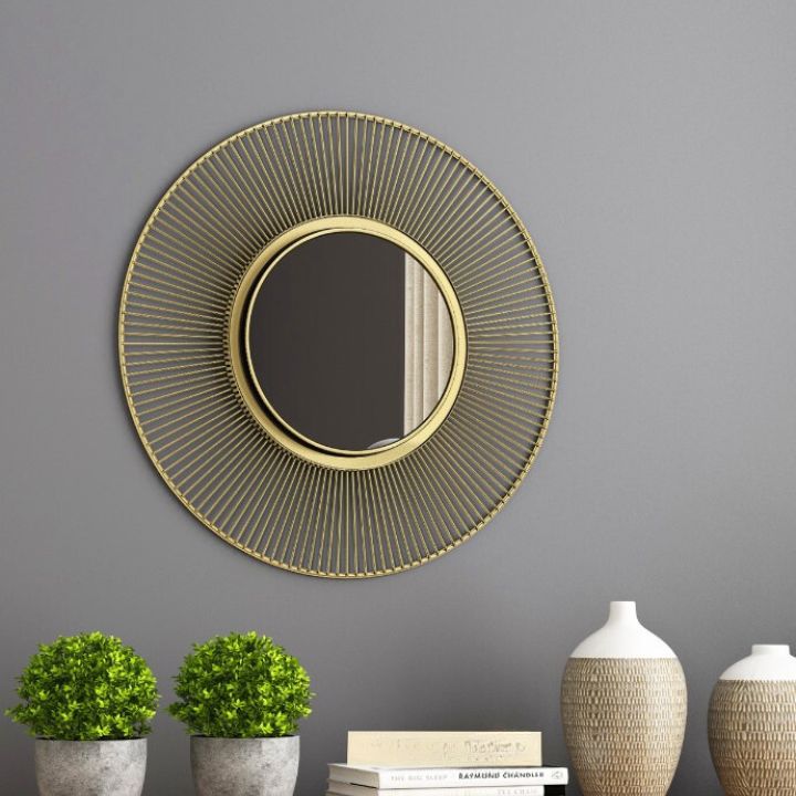 Metallic decorative wall mirror by The Gharnish with a 24-inch diameter, featuring a modern, reflective surface and stylish frame.
