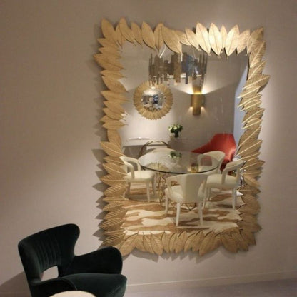 Gold plated leaves wall mirror by The Gharnish, 24x15 inches, featuring a decorative leafy frame for elegant interior decor.