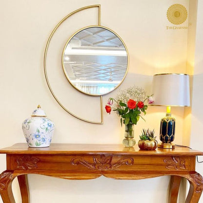 Half Moon metallic wall mirror by The Gharnish, 27x35 inches, featuring a sleek, reflective metallic finish and modern design.