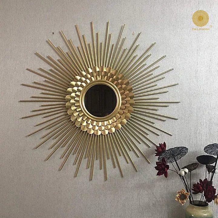 The Gharnish 30-inch plated sun rays metallic wall mirror with a decorative sunburst design and reflective surface.