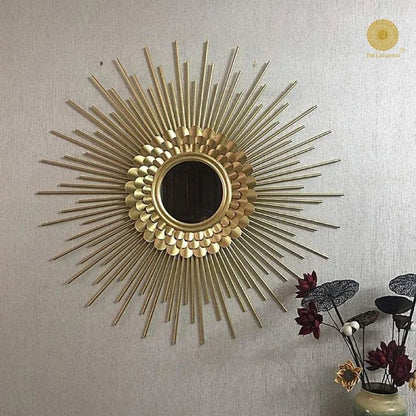 The Gharnish 30-inch plated sun rays metallic wall mirror with a decorative sunburst design and reflective surface.