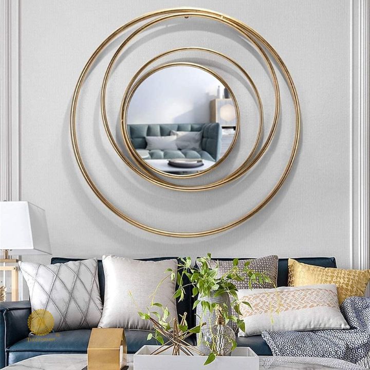 Metallic wall mirror with a ring of rings design, 30-inch diameter, by The Gharnish showing its decorative reflective surface.