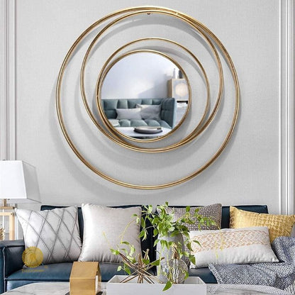 Metallic wall mirror with a ring of rings design, 30-inch diameter, by The Gharnish showing its decorative reflective surface.