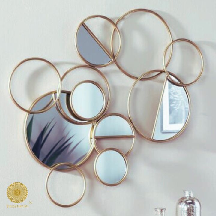 The Gharnish Ring of Rings wall mirror with a 36x26 inch frame featuring multiple circular design elements.