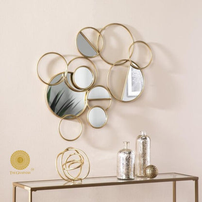 The Gharnish Ring of Rings Wall Mirror, 36x26 inches, featuring a modern circular design with multiple ring accents.