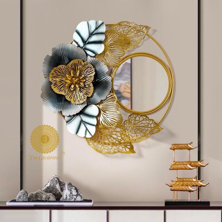 The Gharnish 32-inch single flower wall mirror with a decorative floral frame hanging on a wall.