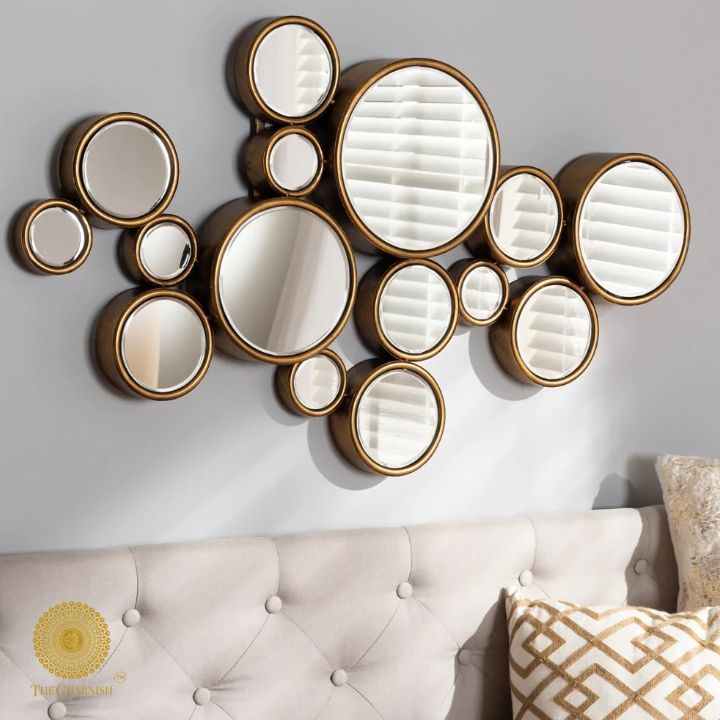 Decorative gold finish wall mirror with 15 circular segments, 48x30 inches, by The Gharnish, ideal for modern interior decor.