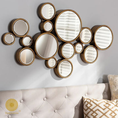 Decorative gold finish wall mirror with 15 circular segments, 48x30 inches, by The Gharnish, ideal for modern interior decor.
