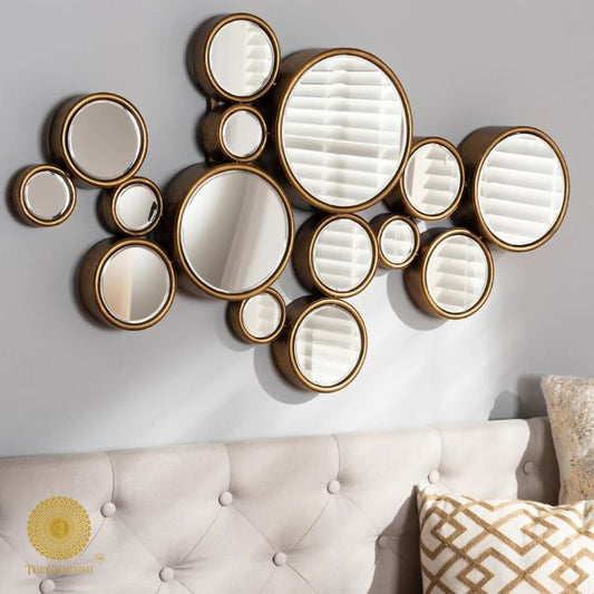 Decorative gold finish wall mirror with 15 circular segments, 48x30 inches, by The Gharnish, ideal for modern interior decor.