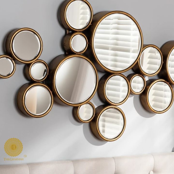 Decorative gold-finish 15 circles wall mirror by The Gharnish, 48x30 inches, featuring a modern circular design for stylish decor.