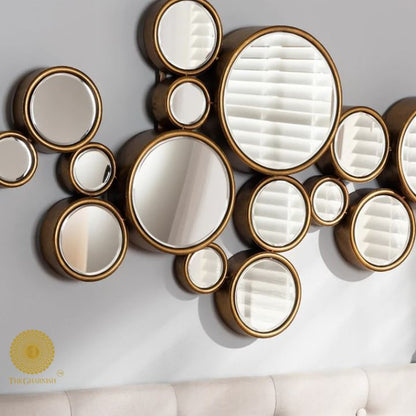 Decorative gold-finish 15 circles wall mirror by The Gharnish, 48x30 inches, featuring a modern circular design for stylish decor.