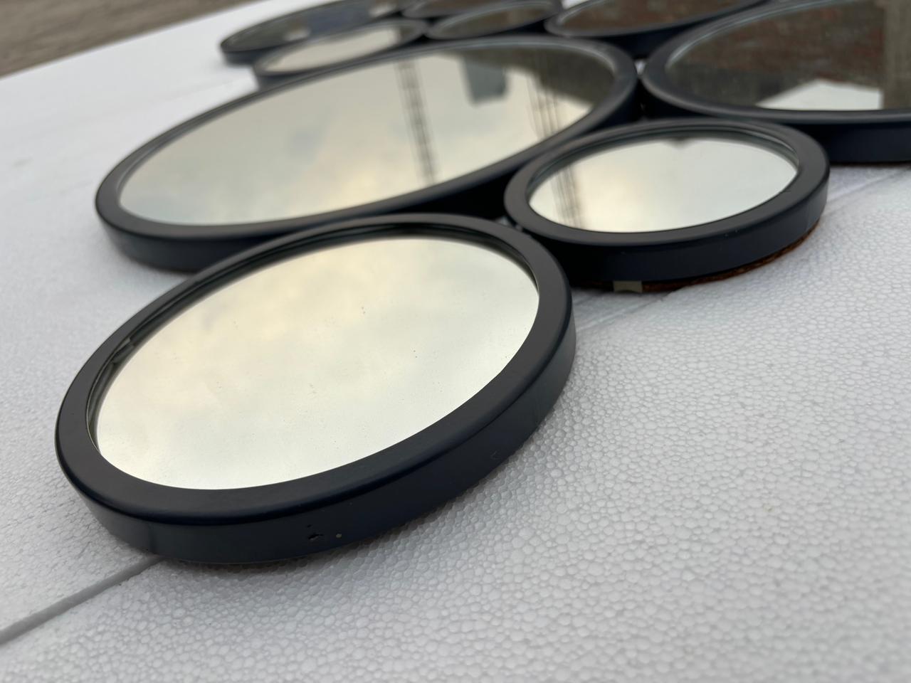 Decorative gold-finish wall mirror with 15 circular frames, measuring 48x30 inches, by The Gharnish.