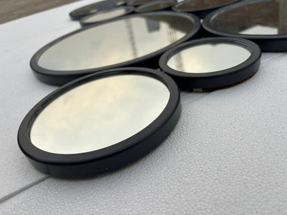 Decorative gold-finish wall mirror with 15 circular frames, measuring 48x30 inches, by The Gharnish.