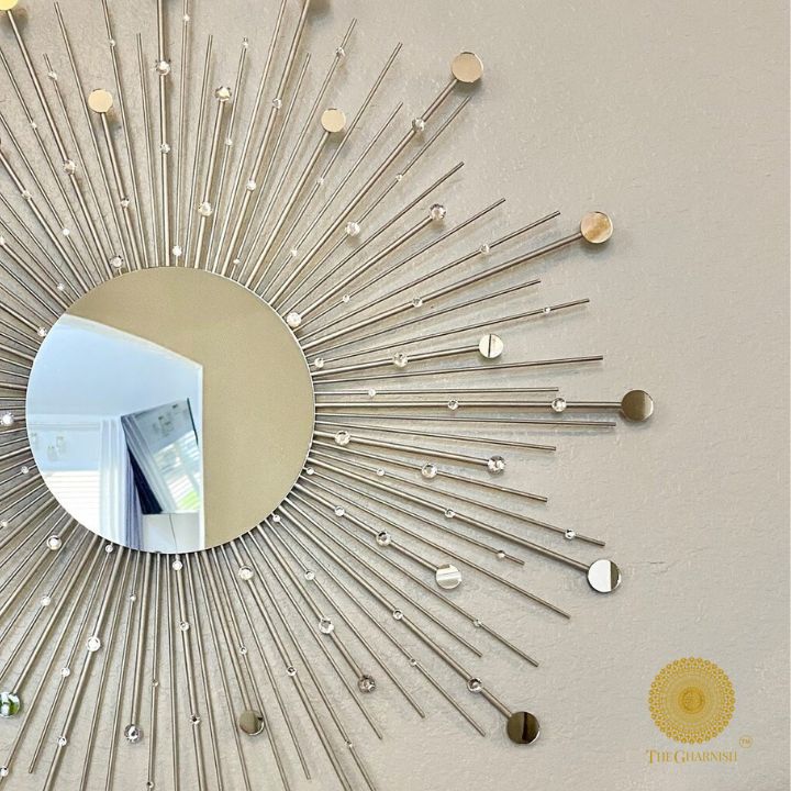 Silver wall mirror with sprinkled gold rays design, 30-inch diameter, by The Gharnish. Reflective surface with decorative frame.