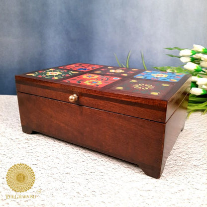 Colorful wooden jewellery box from The Gharnish, featuring multiple compartments for storing necklaces, rings, and bracelets.