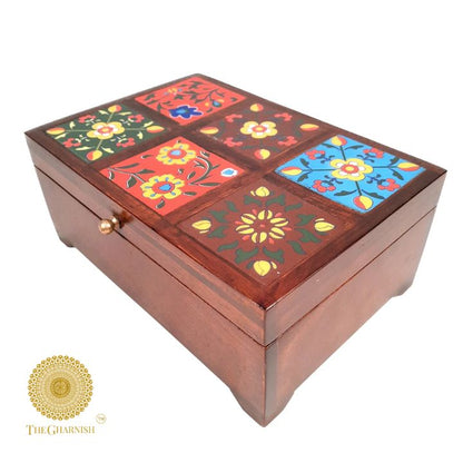 Multicolored wooden jewelry box from The Gharnish, featuring intricate decor and multiple compartments for organizing accessories.