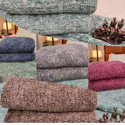 Stacks of textured towels in various colors with a blurred background.