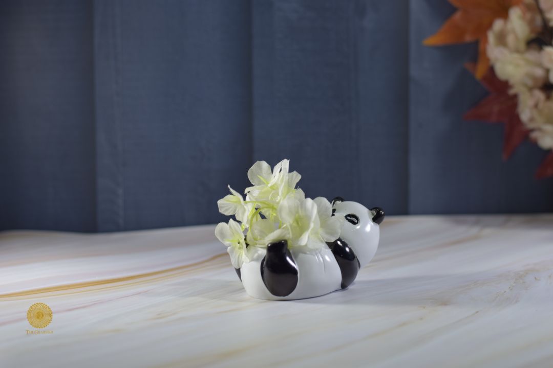 Miniature panda figurine artwork by TheGharnish displayed in a small decorative pot on a wooden surface.