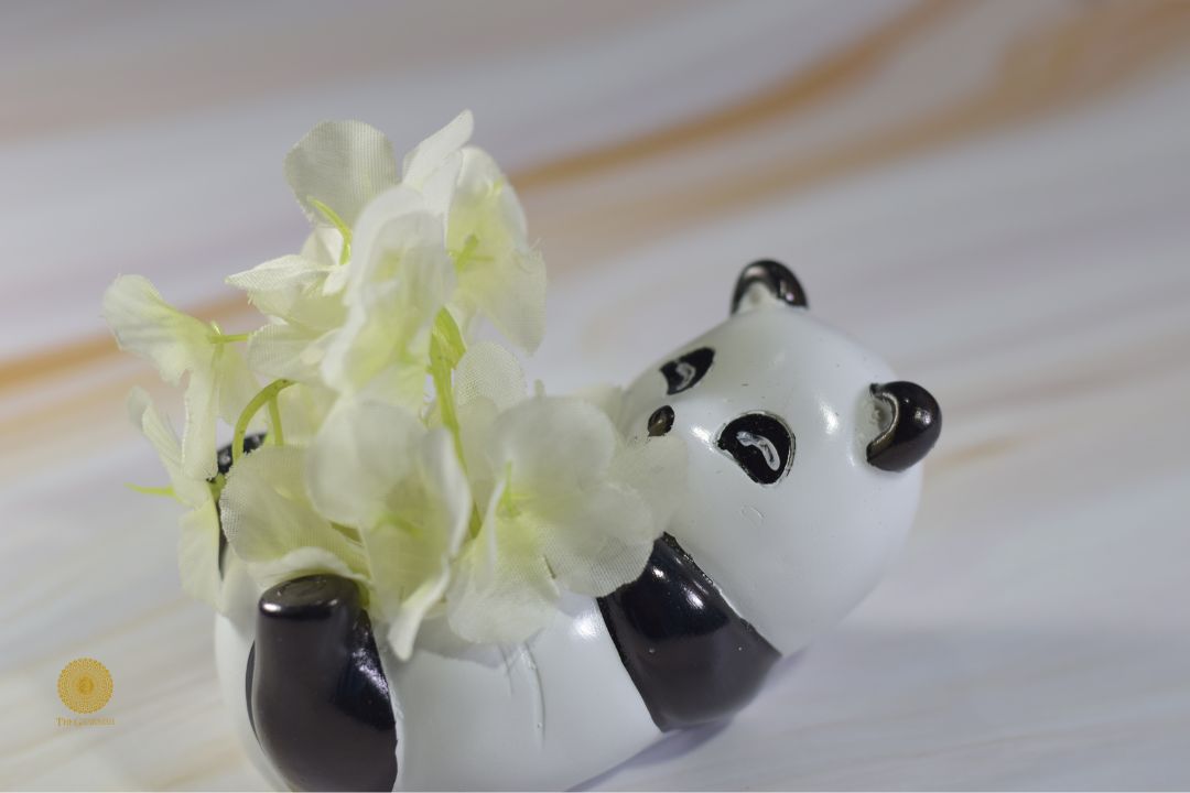 Miniature panda-shaped ceramic pot artwork by TheGharnish, featuring detailed panda design and a small, decorative pot.