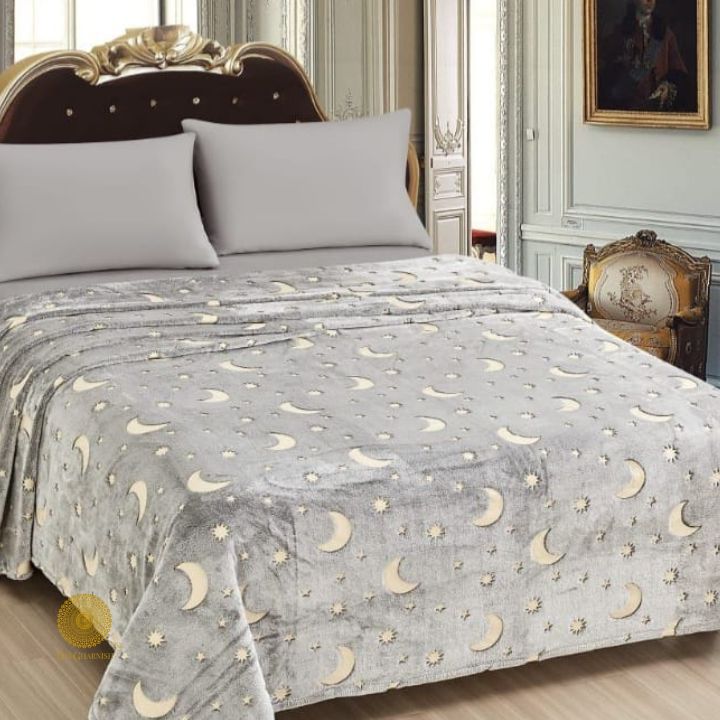Glow in dark flannel blanket for kids by TheGharnish, soft bedding with luminous stars and moon design for cozy nights.