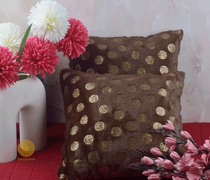 Set of two designer gold printed cushion covers by TheGharnish, featuring elegant decorative patterns on soft fabric.