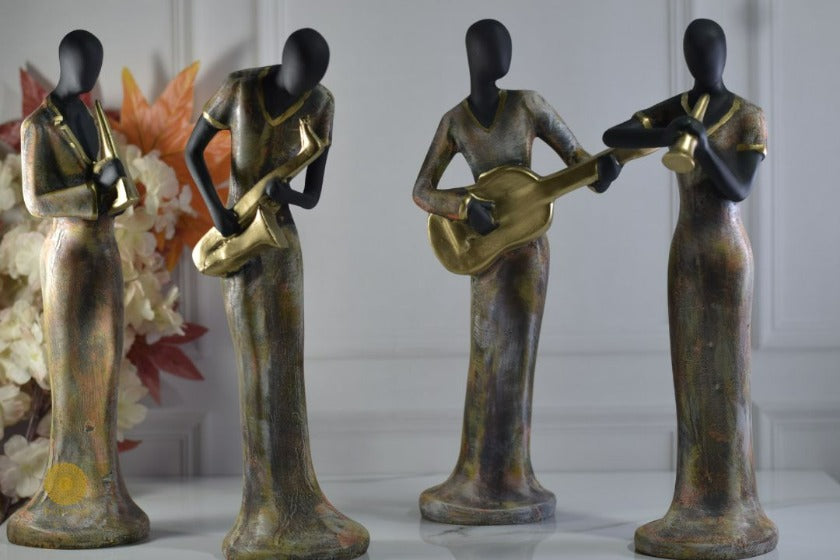 Golden women music band figurine by TheGharnish, detailed sculpture of women musicians with musical instruments.