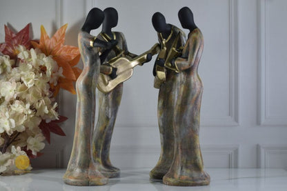 Golden women music band figurine by TheGharnish, detailed sculpture of women playing musical instruments, decorative collectible figurine.