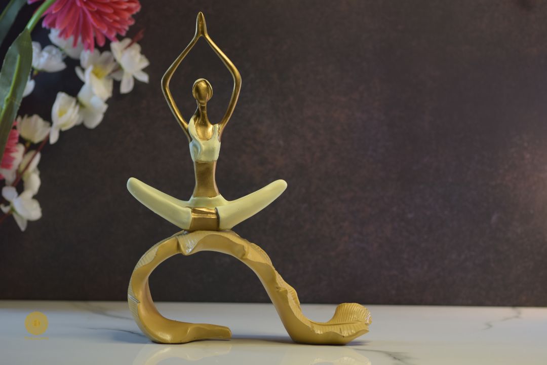 TheGharnish yoga figurine depicting a lady practicing yoga on a banana leaf, showcasing a serene pose and detailed craftsmanship.