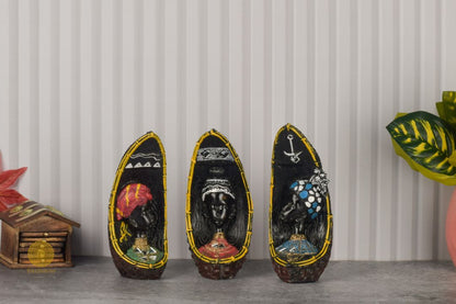 Set of 3 African face figurine table accents by TheGharnish, featuring detailed carved faces for decorative display.