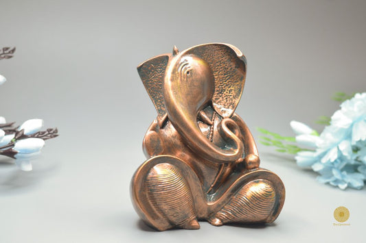 Resting Ganesha figurine showpiece by TheGharnish, detailed Hindu god statue for home decor and spiritual ambiance.
