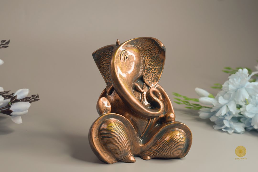 Resting Ganesha figurine showpiece by TheGharnish, depicting the Hindu god in a serene resting pose, made of elegant material.