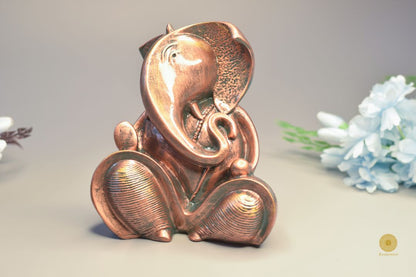 Resting Ganesha gods figurine showpiece by TheGharnish, detailed sculpture of Lord Ganesha in a relaxed pose.