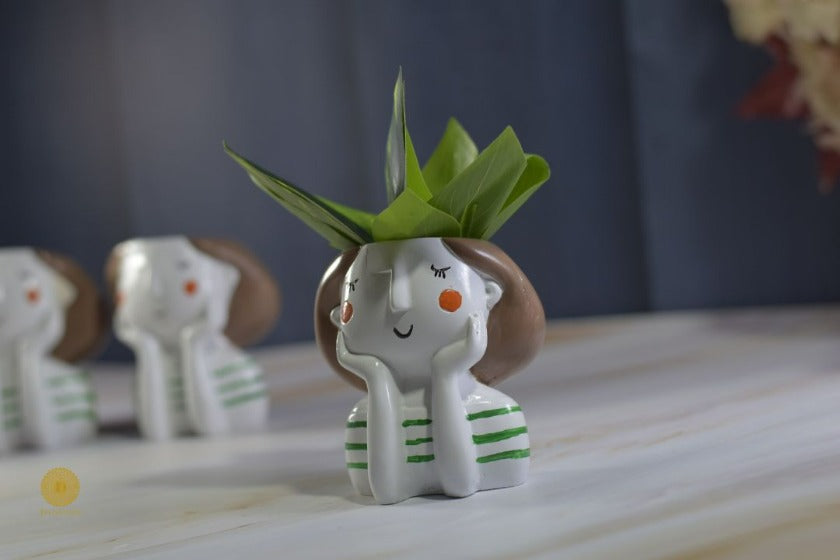 Miniature cute girl face planter by TheGharnish, featuring a detailed facial expression and a small plant opening on top.