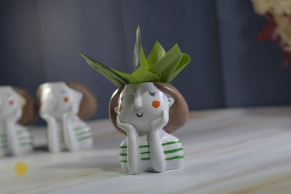Miniature cute girl face planter by TheGharnish, featuring a detailed facial expression and a small plant opening on top.