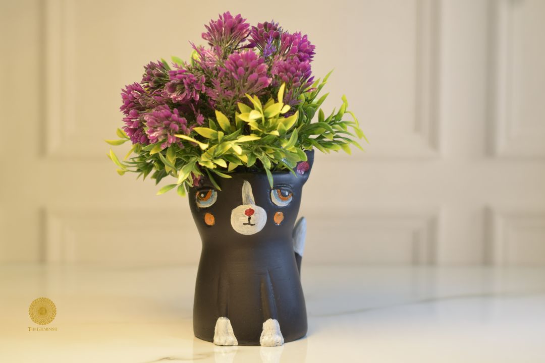 Miniature black cat planter from TheGharnish featuring a small, detailed black cat figure with a hollow interior for plants.