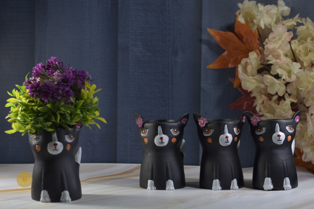 Miniature black cat planter by TheGharnish, featuring a cute black cat shape with a hollow interior for small plant display.