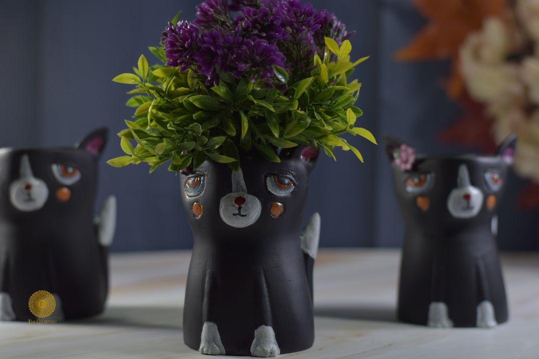 Miniature black cat planter by TheGharnish, featuring a small black cat-shaped container with a hollow interior for plants.