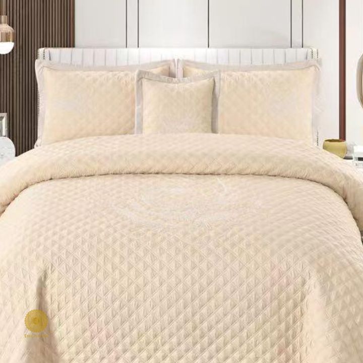 TheGharnish Paradise solid color quilted bedcover with heavy embroidery, showcasing intricate stitched patterns on a plush fabric.