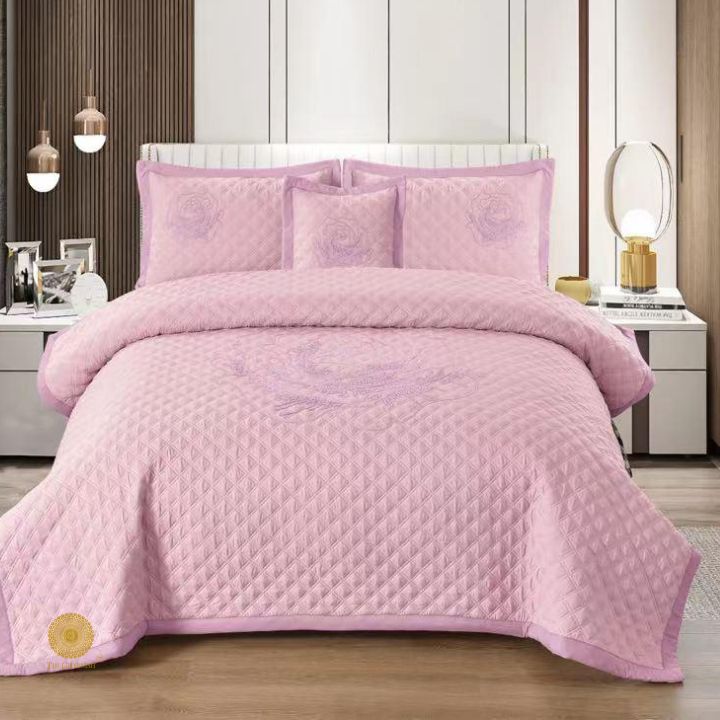 TheGharnish Paradise solid color quilted bedcover with heavy embroidery pattern on a neatly made bed in a cozy bedroom setting.
