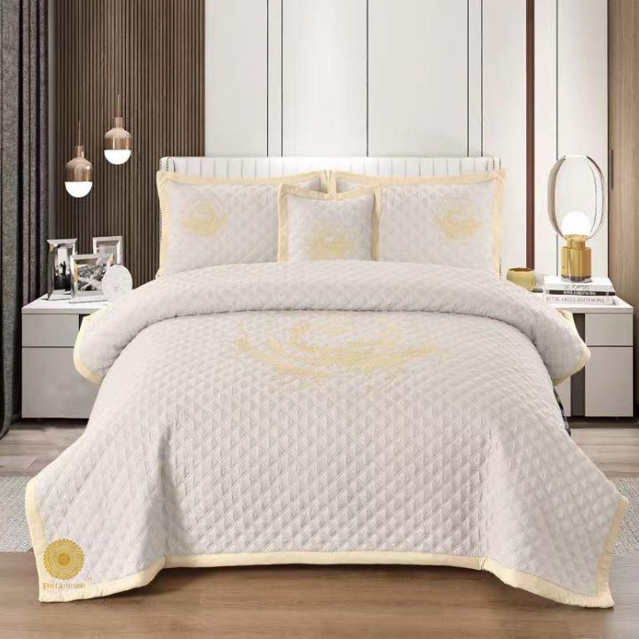 TheGharnish Paradise solid color quilted bedcover with heavy embroidery, showcasing intricate stitching and luxurious fabric design.