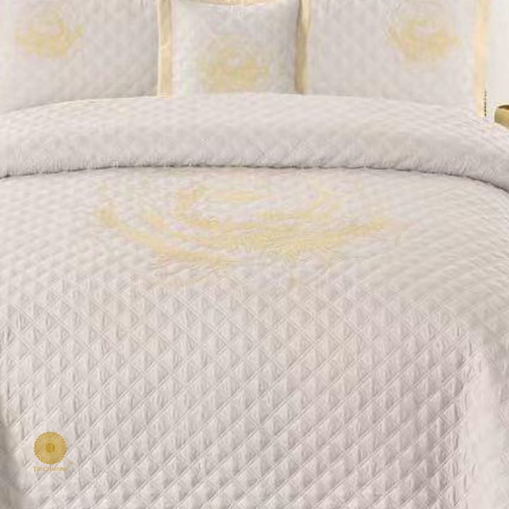 TheGharnish Paradise solid color quilted bedcover with intricate heavy embroidery, showcasing detailed stitching and vibrant fabric texture.