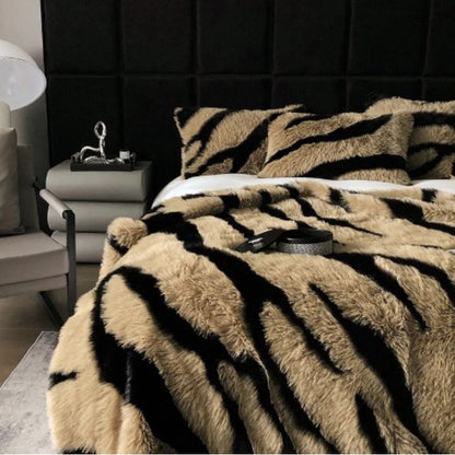Zebra Print Faux Fur Blanket Set. Crafted with ultra-soft, high-density faux fur, this blanket brings a bold and exotic flair to your space with its striking black and white zebra pattern.