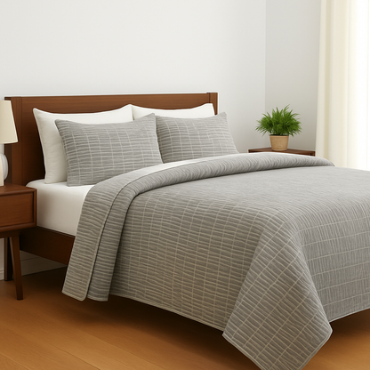 Bed with gray checkered duvet and pillows in a bedroom setting.