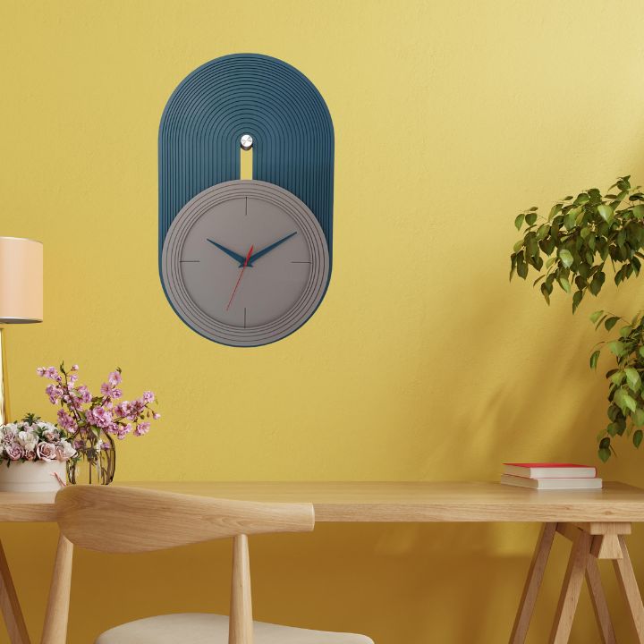 Elevate your home decor with our Modern Nordic Wall Clock, a perfect blend of minimalist design and functional elegance. Featuring a matte grey dial set against a teal blue arched panel with fine grooves, this clock adds a contemporary touch to any living room, bedroom, or office space. The sleek blue and red hands ensure precise timekeeping,deal for lovers of Scandinavian and modern aesthetics.