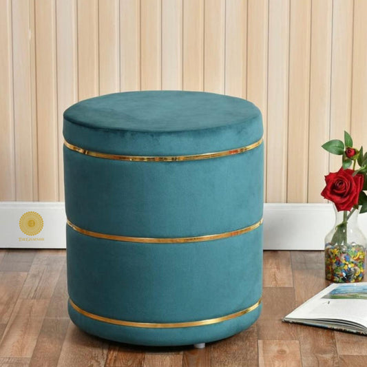 Light blue fabric ottoman stool by The Gharnish, versatile pouffe for seating or decoration in living spaces.