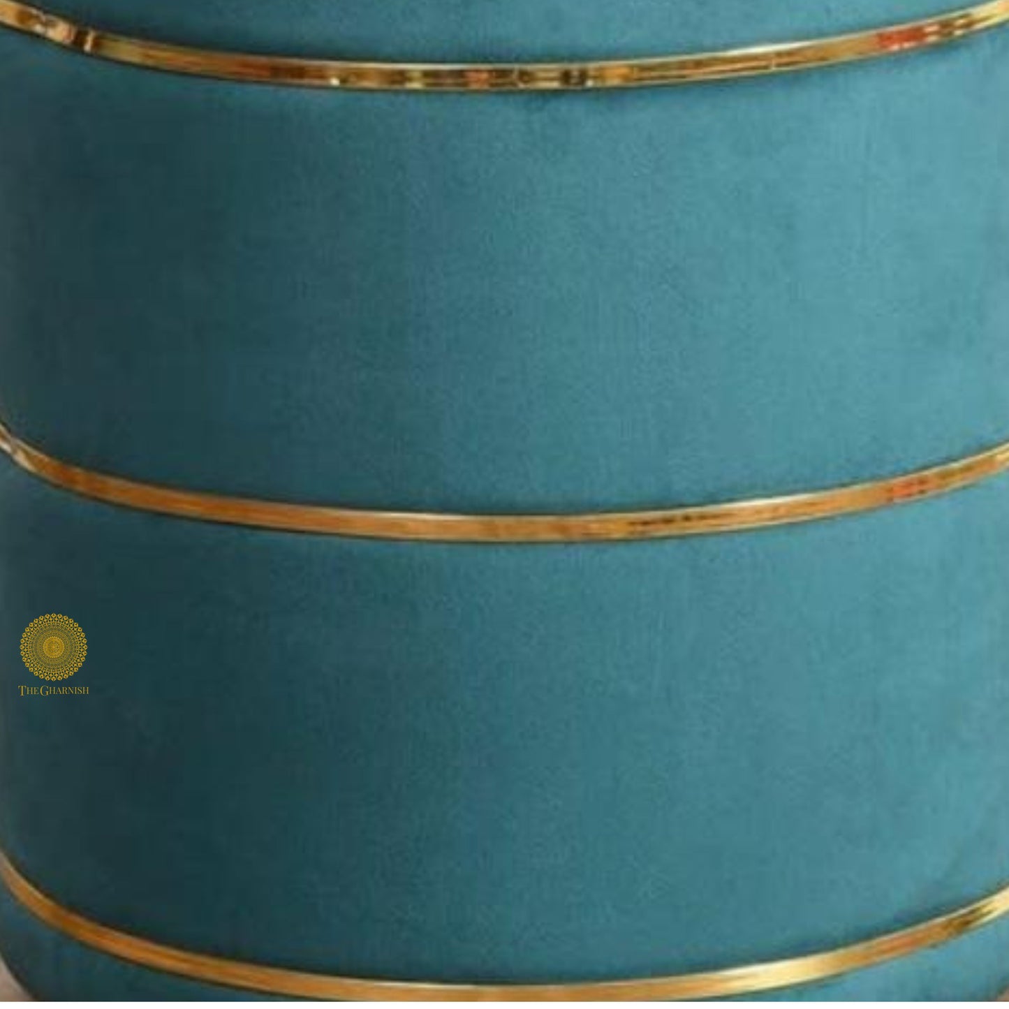 Light blue fabric ottoman pouffe stool by The Gharnish, featuring a soft, cushioned surface and rounded design.