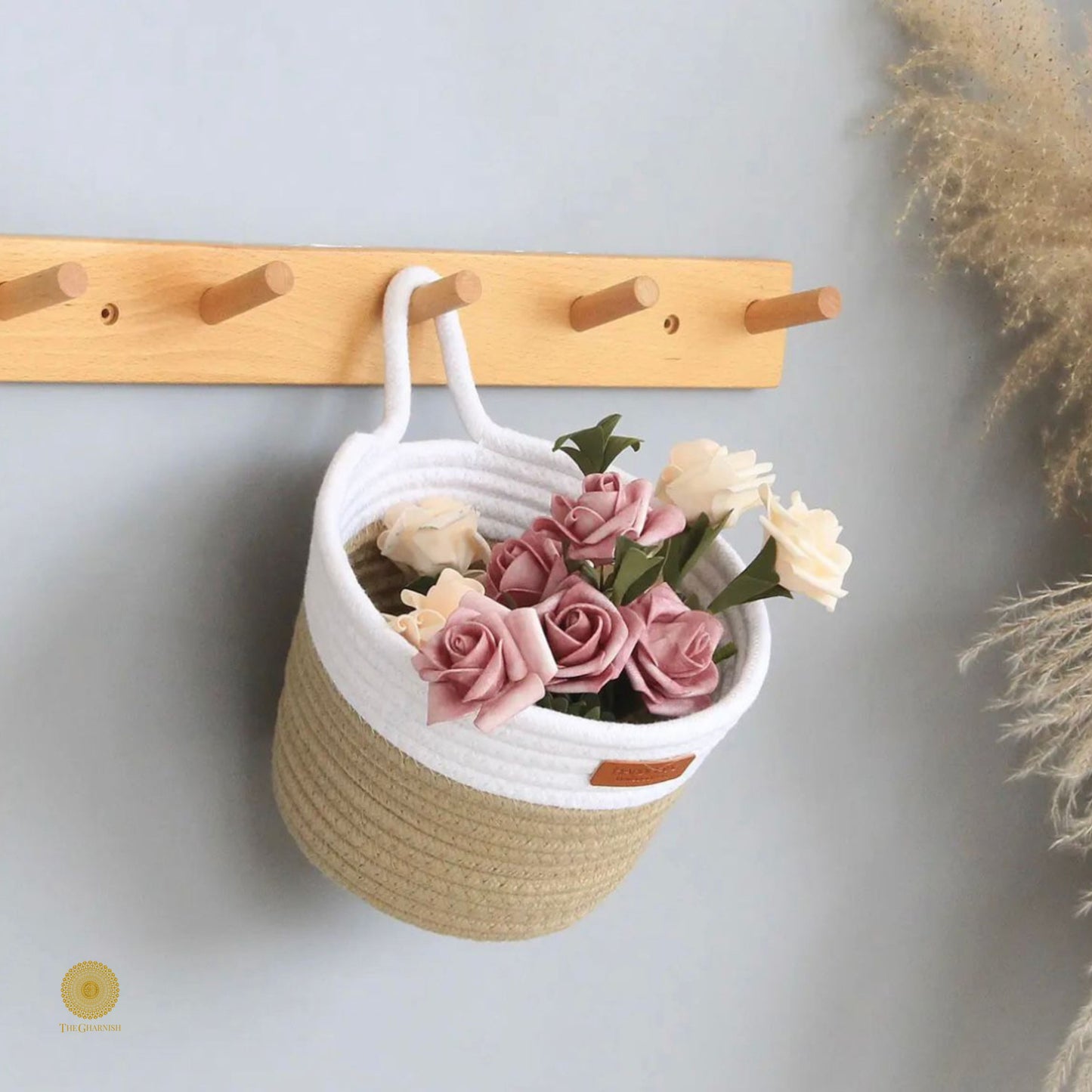 White and brown wall hanging basket from TheGharnish, made of woven material, suitable for storage or decorative display.