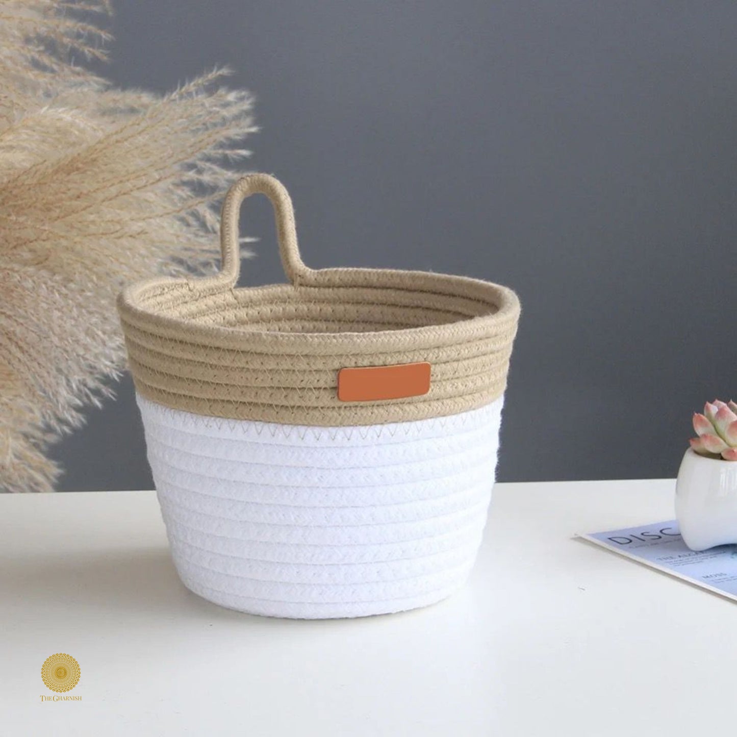White and brown wall hanging basket by TheGharnish, woven basket with handles suitable for wall decor and storage.
