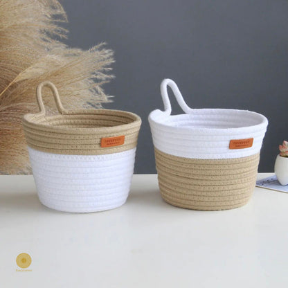 White and brown wall hanging basket by TheGharnish, crafted from woven material, ideal for storage or decorative use.